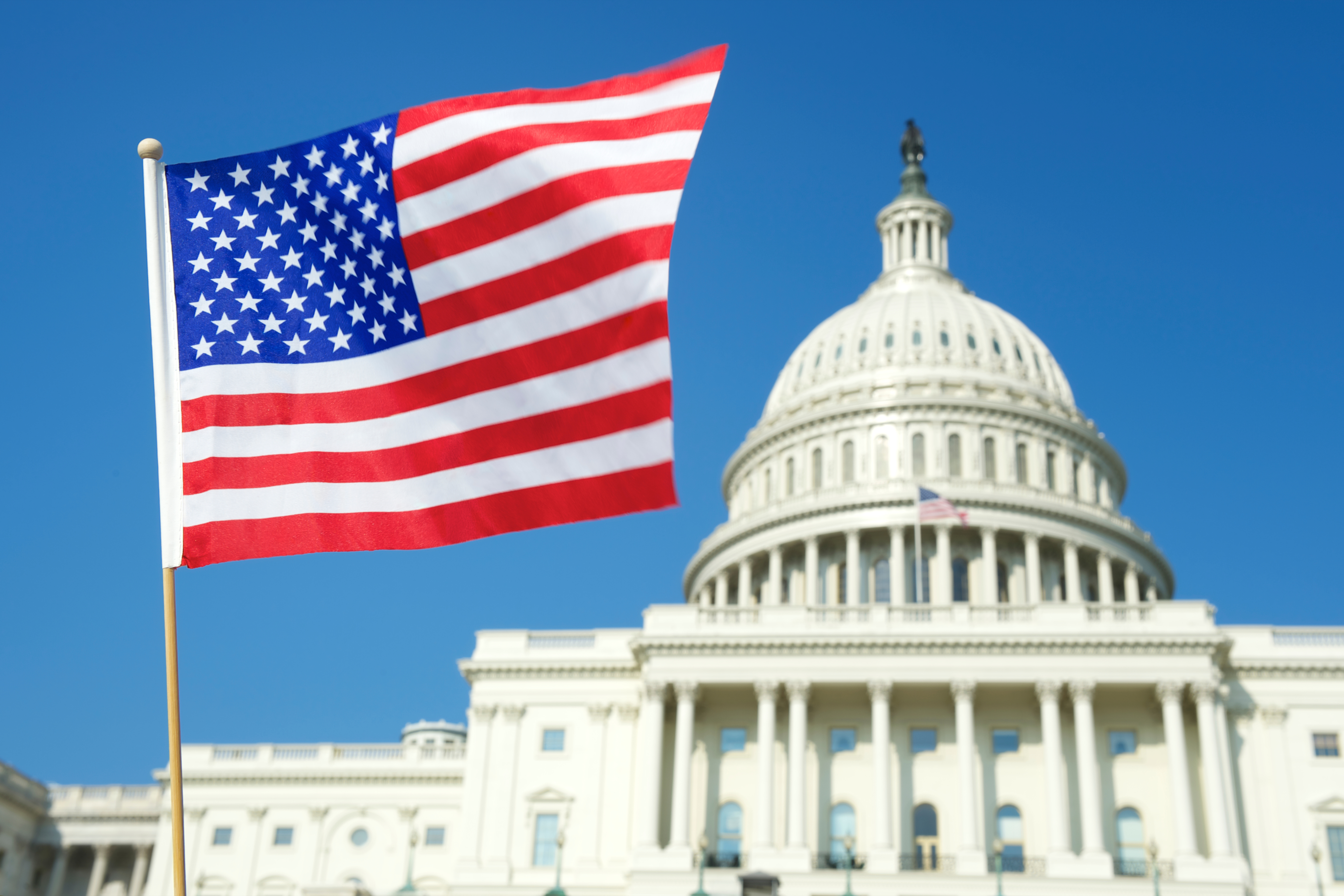 American flag against the background of the building that regulates the E-2 visa
