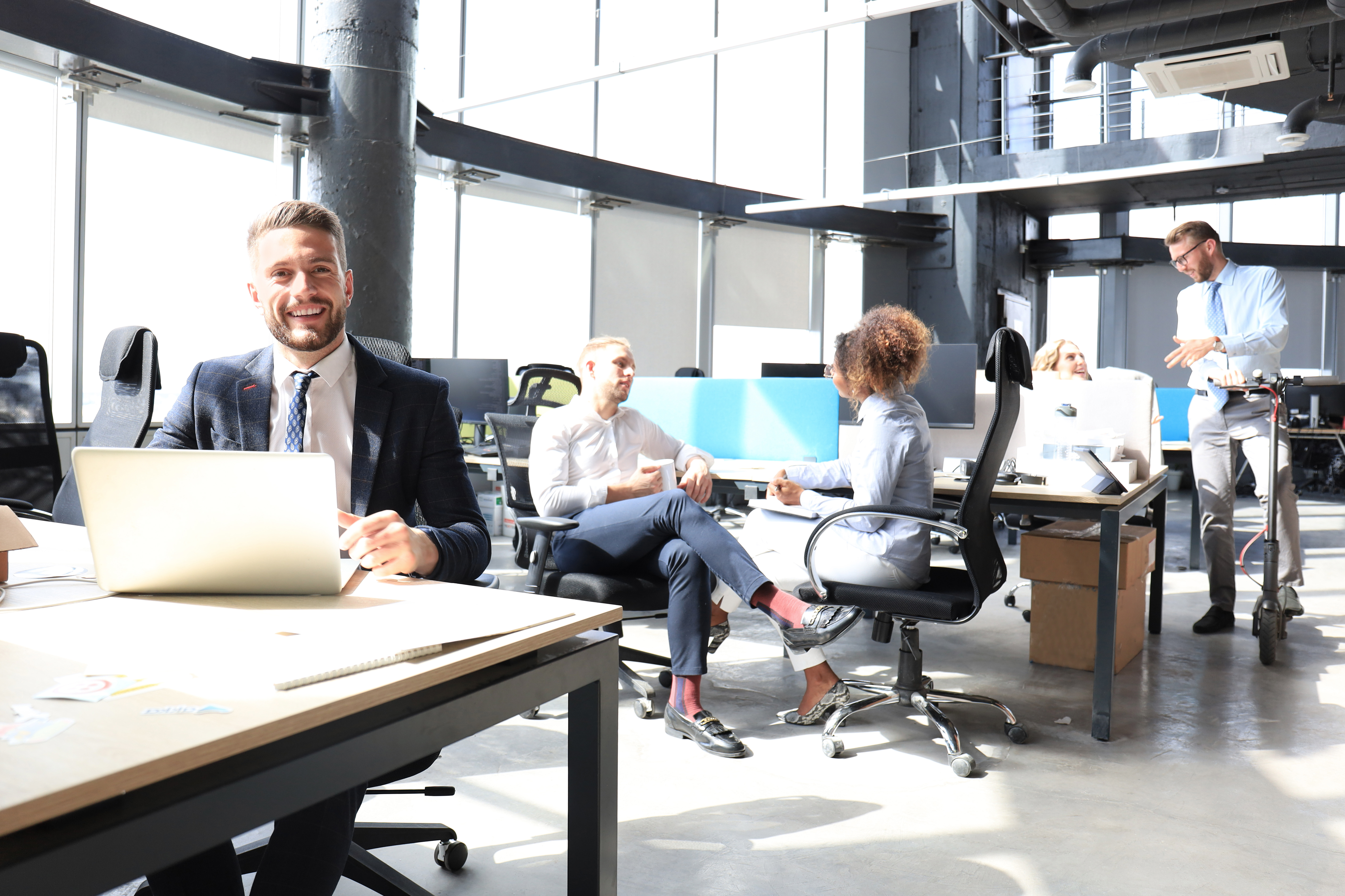 Man with laptop at work on Essential Skills visa in New Zealand office